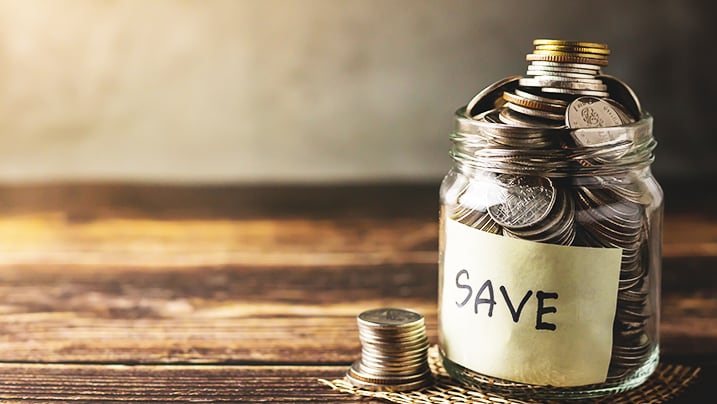 A piggy bank jar with coins