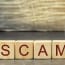 SCAM alphabet blocks with a magnifying glass