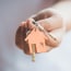 person's hand holding house key