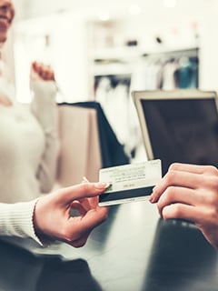 woman handing over a credit card
