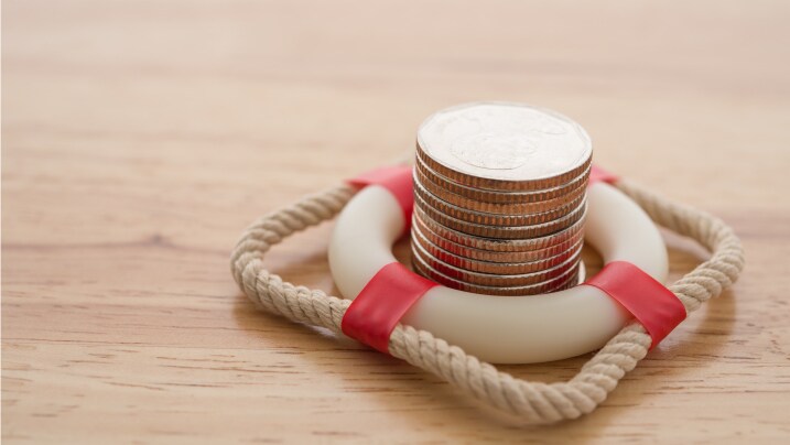 Stacked coins in a lifebelt