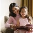 little girl siting on mother's lap