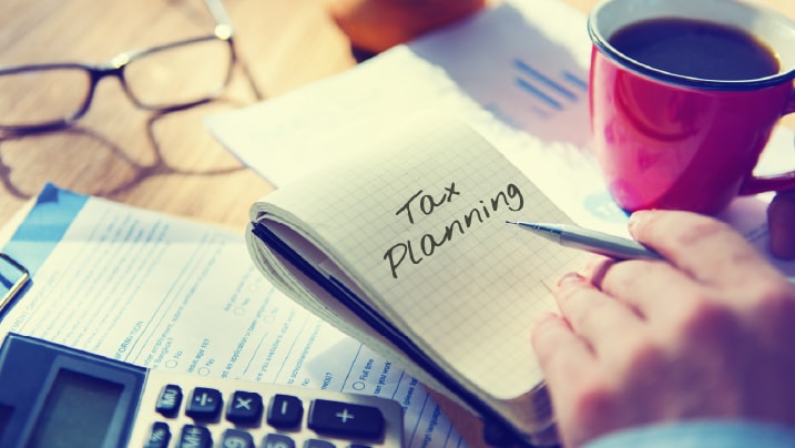 A financial planner analyzing tax documents to enhance wealth growth.