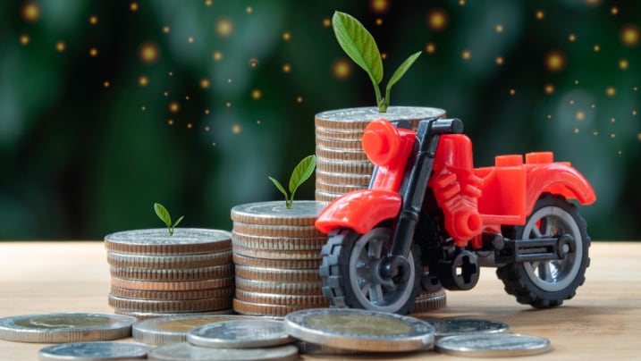 coins stacked together with a bike toy