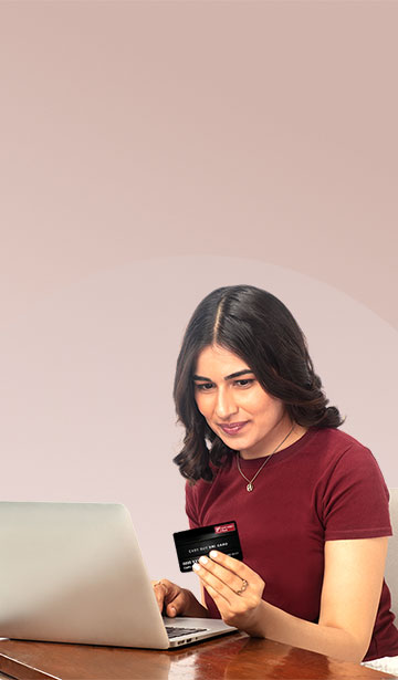 Woman with laptop using her Easy Buy EMI Card